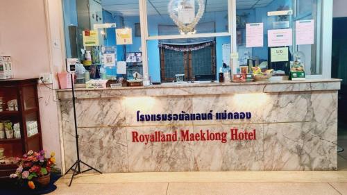 a counter in a store with a sign on it at Royal Land Mae Klong Hotel in Samut Songkhram
