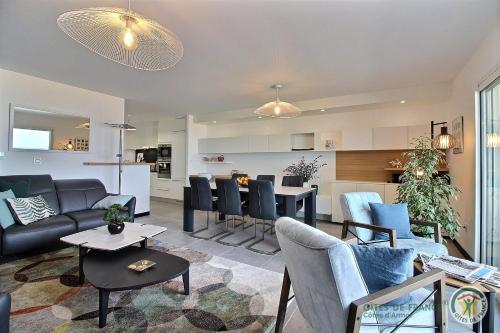 un salon avec un canapé et une table dans l'établissement L'emeraude, à Plérin