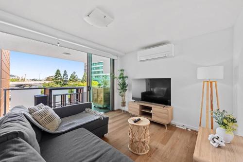 a living room with a couch and a flat screen tv at Inner City Action 3Bed 2Bath 1Car 3Balconies in Brisbane