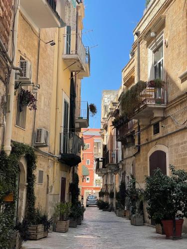 an alley in an old town with buildings at Palazzo Verrone in Bari