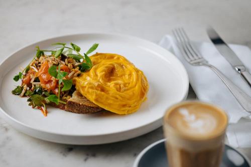 a white plate with a sandwich and a cup of coffee at Re’em Yarra Valley in Gruyere