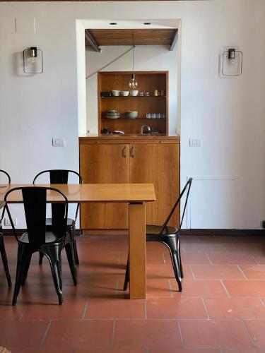 a dining room with a wooden table and chairs at Palazzo Verrone in Bari