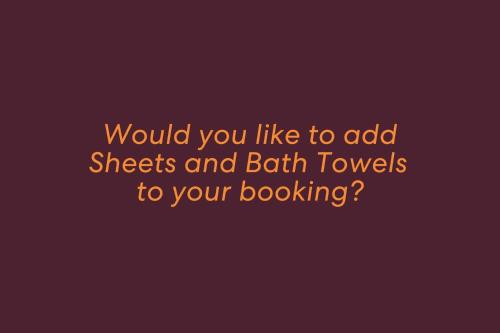 a purple background with the words would you like to add sheets and british at Baia Villa air con WiFi and views of Fingal Beach in Fingal Bay