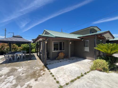 a small house with a patio and a table at The Beach Inn SHIRAKO in Shirako