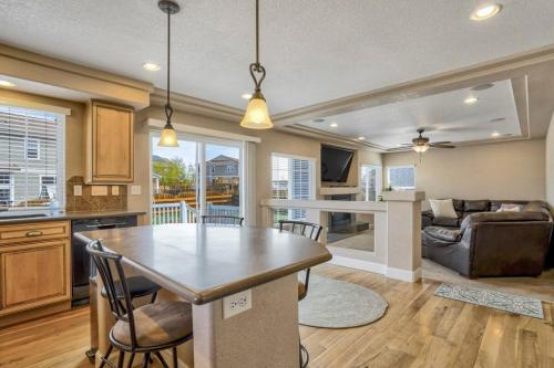 a kitchen and living room with a table and chairs at 4BR Hot Tub Pool Table, Ping Pong, Foosball! in Peyton