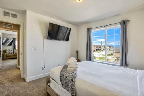 a bedroom with a bed and a large window at 4BR Hot Tub Pool Table, Ping Pong, Foosball! in Peyton