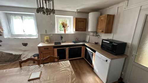 une cuisine avec un évier et un micro-ondes dans l'établissement Gite en Cevennes 4 personnes, à Ponteils-et-Brésis