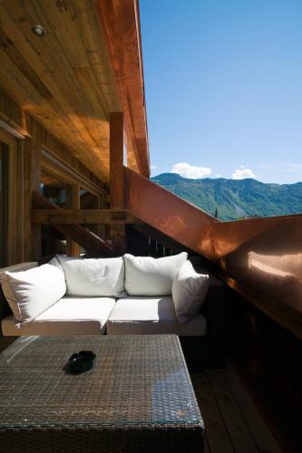 a white couch sitting in a room with a view at Neuprantl Apartments in Lana