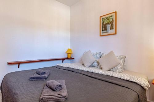 a bedroom with a bed with towels on it at Cliff View Terrace By Dream Homes Tenerife in Puerto de Santiago