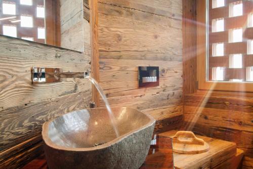a bathroom with a tub with a water fountain at Neuprantl Apartments in Lana