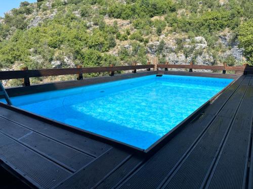 a swimming pool on the deck of a house at Kipi Mountain Resort in Kipoi