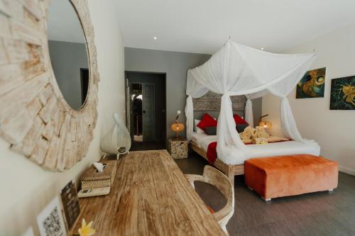 Ένα ή περισσότερα κρεβάτια σε δωμάτιο στο Maylie Bali Villa & Bungalows