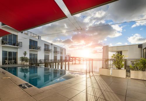 a view from the balcony of a building with a swimming pool at Trinity Wharf Tauranga in Tauranga