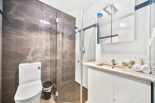 a bathroom with a shower and a toilet and a sink at Stylish 2 Story Terrace House in Chippendale in Sydney