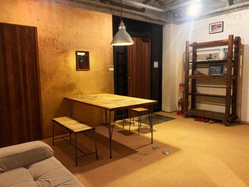 a living room with a wooden table and chairs at The Rainbow Room in Kyoto