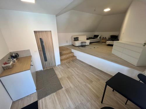 a large living room with a staircase and a living room at Statek in Libice nad Cidlinou