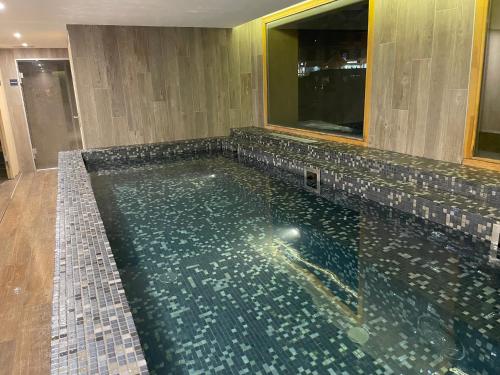 une grande piscine dans une chambre d'hôtel dans l'établissement Superbe appartement les 2 Alpes, à Les Deux Alpes