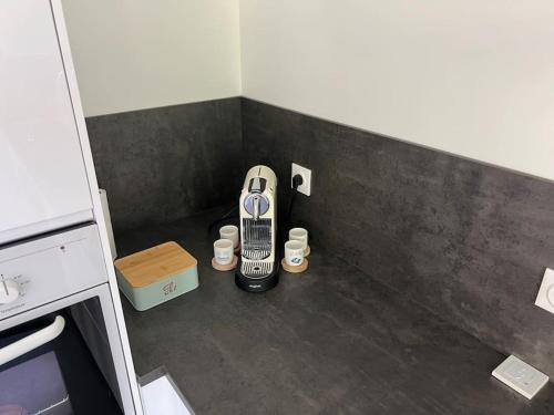 a room with a cell phone in the corner of a kitchen at Cœurs de l ouest - appart avec jardin in Craponne