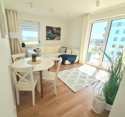 a living room with a table and chairs and a couch at VIP APARTAMENTY Lubelska in Rzeszów