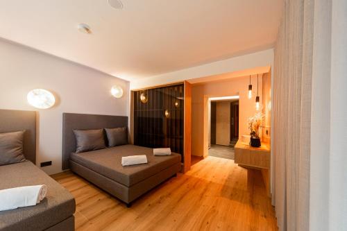 a living room with a bed and a couch at Eden Apartments in Siusi