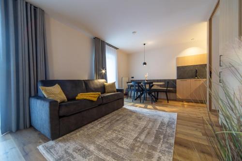 a living room with a couch and a table at Eden Apartments in Siusi