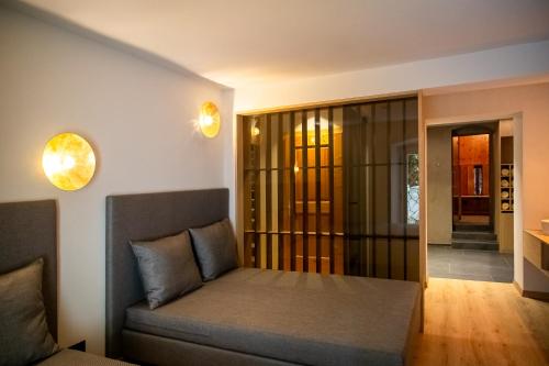 a living room with a couch and a glass door at Eden Apartments in Siusi