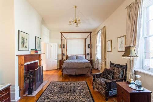 a living room with a fireplace and a bed at Grand Old Duke in Hobart