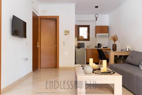 a living room with a couch and a table at Endless Blu Apartments in Pyrgadikia