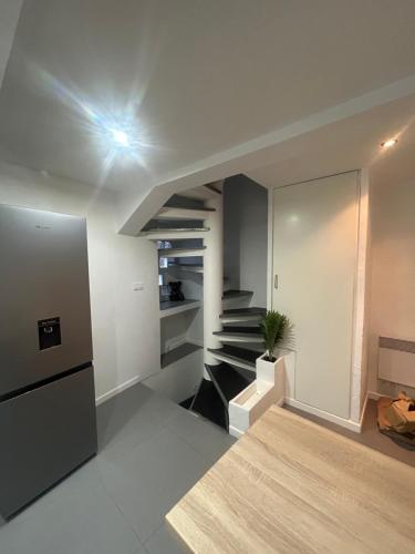 a living room with a staircase and a house at Maison de village in Berre-les Alpes