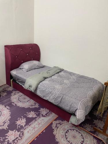 1 dormitorio con 1 cama y 2 alfombras en Shaida homestay, en Kota Bharu