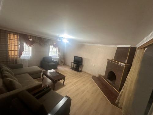 a living room with a couch and a fireplace at Ori Villa in Likani