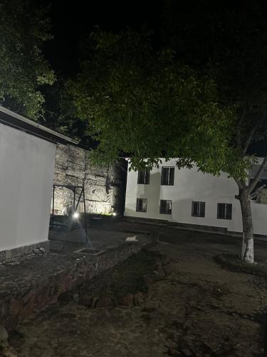 a building with a tree in front of it at night at Ori Villa in Likani