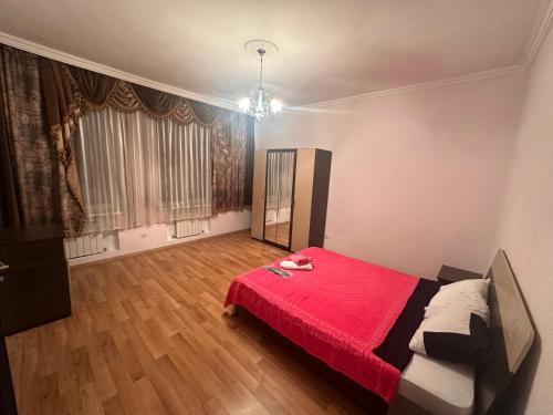 a bedroom with a bed with a red blanket at Ori Villa in Likani