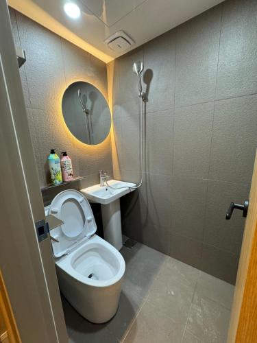 a small bathroom with a toilet and a sink at Well Plus Guest House in Seoul
