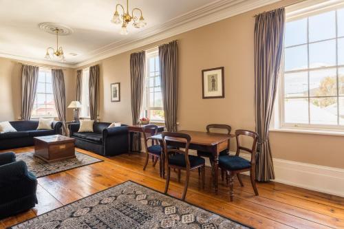 a living room with a table and chairs at Grand Old Duke in Hobart