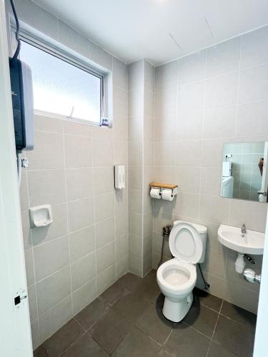 a bathroom with a toilet and a sink at Comfy Cafe 43 Homestay- Holiday Home in Tanah Rata