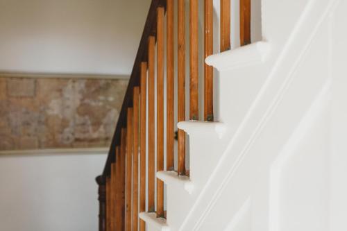 a stairwell with white stairs and wooden walls at Grand Old Duke in Hobart