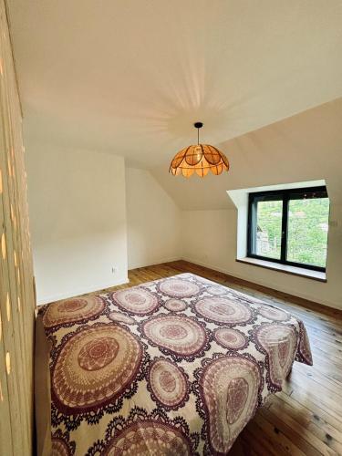 une chambre avec un grand lit dans une pièce dans l'établissement La haut Maison a la campagne, à Mandailles