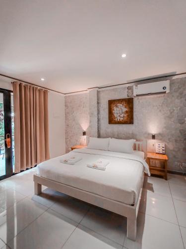 a bedroom with a large white bed in a room at Alona Northland Resort in Panglao Island