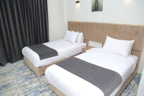 a hotel room with two beds in a room at Elminya Compound in Al Minya