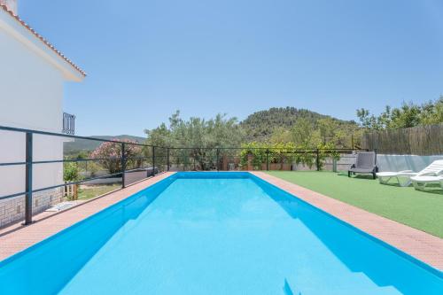 a swimming pool on the balcony of a house at El Cachorro in Altura