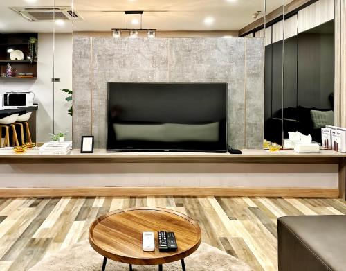a living room with a large flat screen tv at State Tower Bangkok in Bangkok
