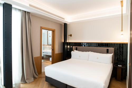 Katil atau katil-katil dalam bilik di Legado Magdalena Hotel