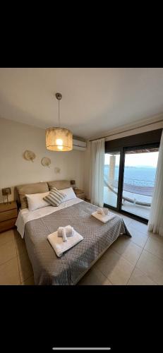 a bedroom with a bed with two towels on it at VL Luxury Villa in Kiveri
