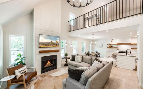 a living room with a couch and a fireplace at Farmhouse in the Burg in Gatlinburg