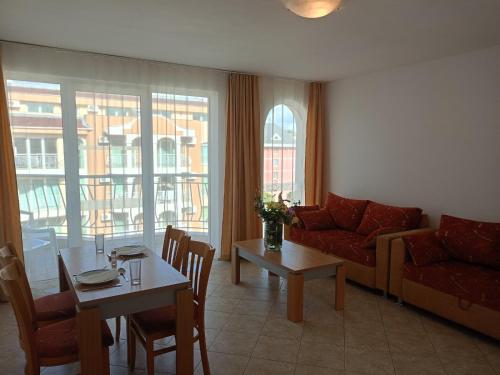 a living room with a couch and a table at CunninghamsSilver in Sunny Beach