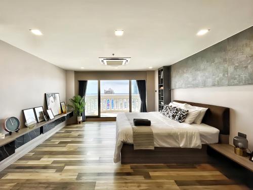 a bedroom with a large bed and a large window at State Tower Bangkok in Bangkok