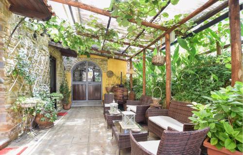 an outdoor patio with chairs and tables and plants at Pet Friendly Home In Laureana Cilento in Laureana Cilento