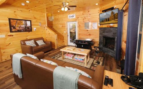 a living room with a couch and a fireplace at Liberty Haven in Pigeon Forge