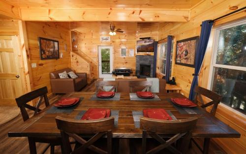a dining room with a table and chairs in a cabin at Liberty Haven in Pigeon Forge
